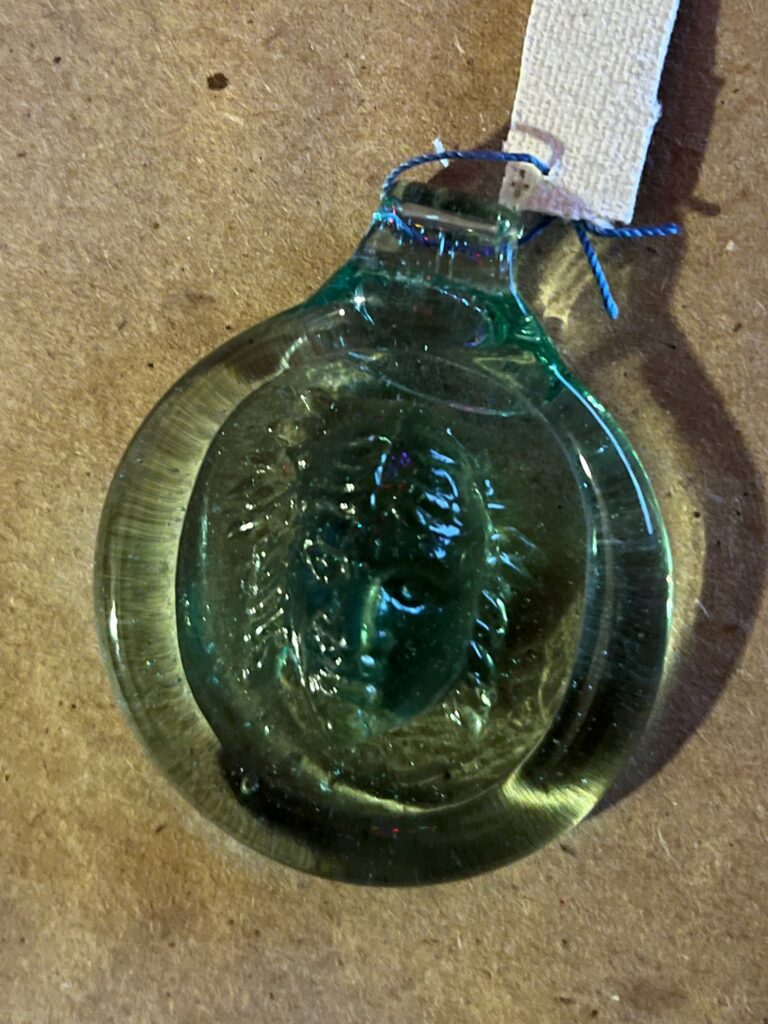 Glass medalion with female face